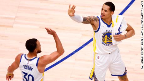 Stephen Curry and Juan Toscano-Anderson celebrate during the win against the Dallas Mavericks.