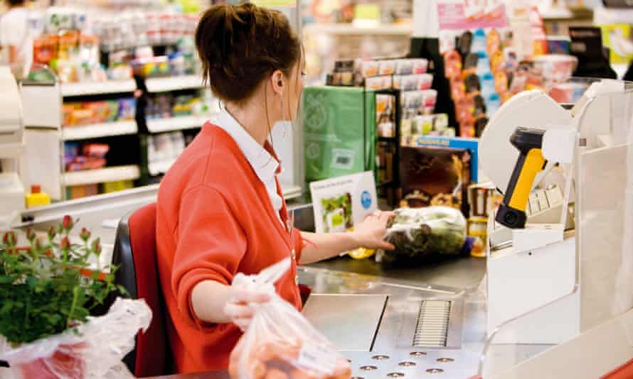 A cashier scans food at the checkout.