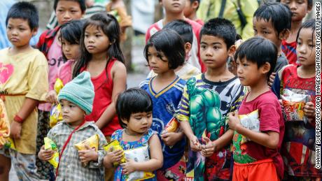 Children stand in a refugee camp along the Thai-Myanmar border.