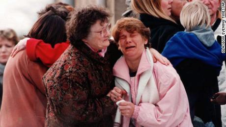 A group of relatives near the elementary school in Dunblane, Scotland, where a gunman killed 16 children and one teacher in 1996.  