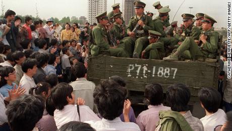 Pro-democracy demonstrators surround a truck filled with Chinese soldiers on their way to Tiananmen Square, May 20, 1989. 