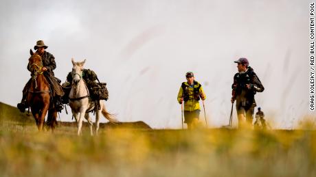 A crew on horseback support Sandes and Griesel during a leg of their Lesotho circumnavigation run.