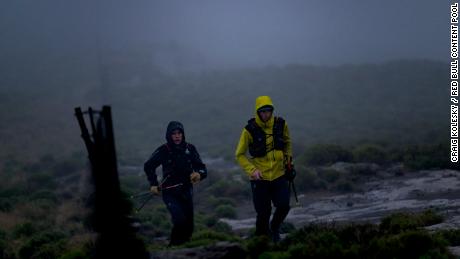 Griesel and Sandes making a big push up one of Lesotho&#39;s many mountains during a particularly rainy day.