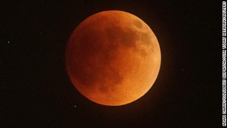 Total lunar eclipse creates dazzling &#39;blood moon&#39; 