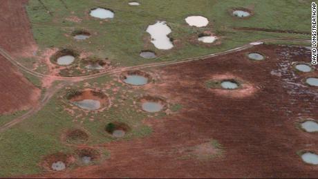 What appear to be ponds are actually water-filled bomb craters from the Vietnam War era, as seen from a helicopter, May 25, 1997, near the northeastern Laotian village of Sam Neau.