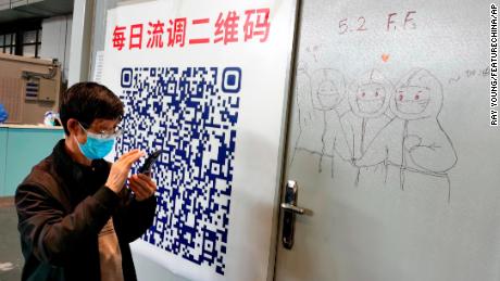 A patient scans the QR code in a temporary hospital for people infected with Covid-19 in Shanghai on April 24.