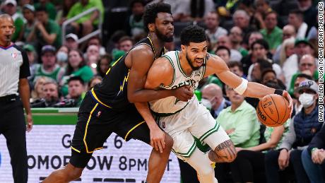 Jayson Tatum drives the ball against Warriors forward Andrew Wiggins.