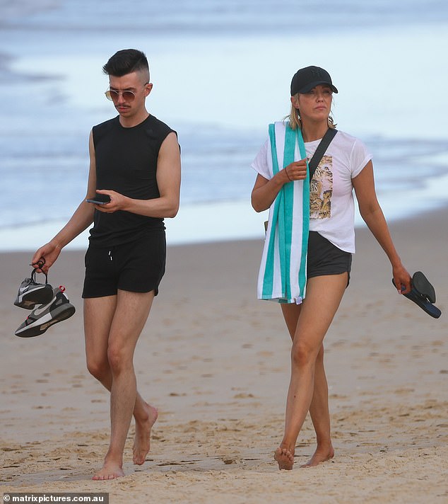 Jacinta later slipped into a pair of black shorts and a tight white T-shirt