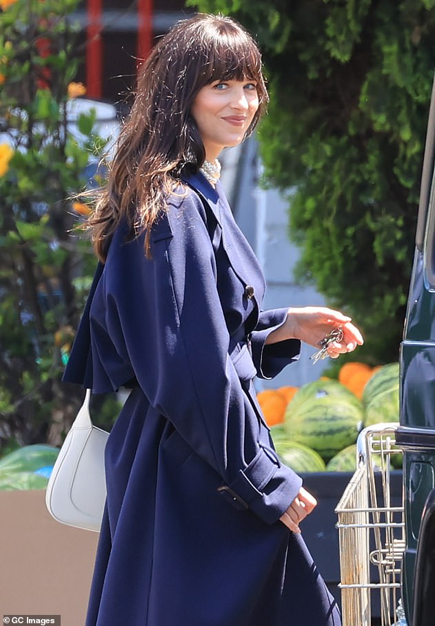 Smiles: The busy actress smiled at photographers who shot snaps of her in the parking of of a supermarket where filming took place