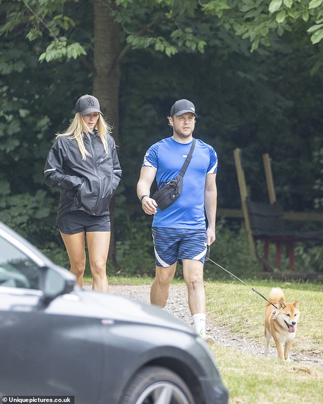 Stroll: Olly looked eye-catching in an all-blue ensemble, made up of patterned shorts and a blue shirt