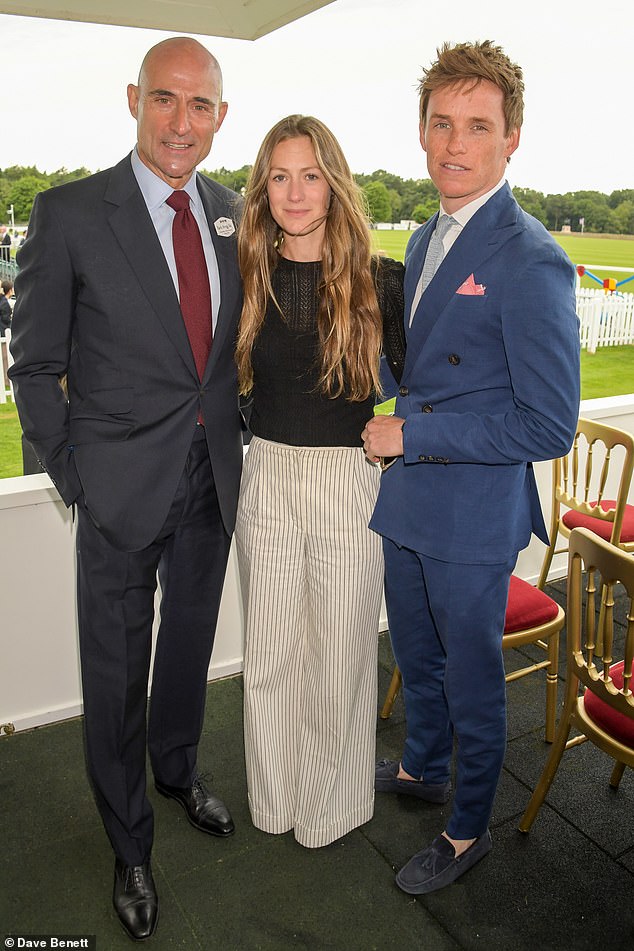 Famous faces: The couple were joined at the event by Hollywood star Mark Strong as they beamed on a balcony