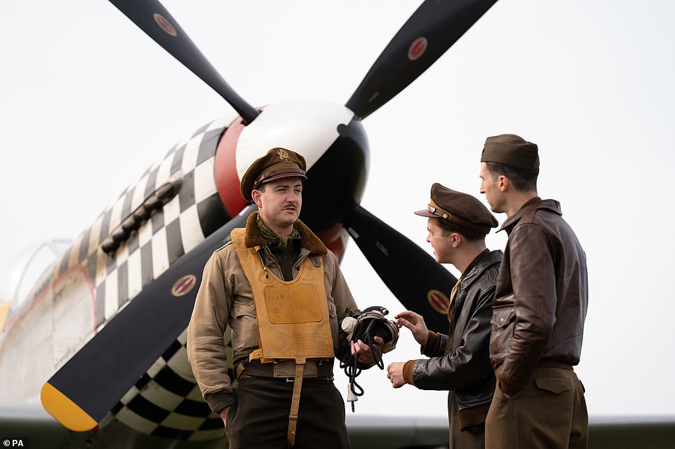 The Spirit of Britain living history group dressed as American Second World War aircrew with TF-51D Mustang 'Contrary Mary' at the airshow