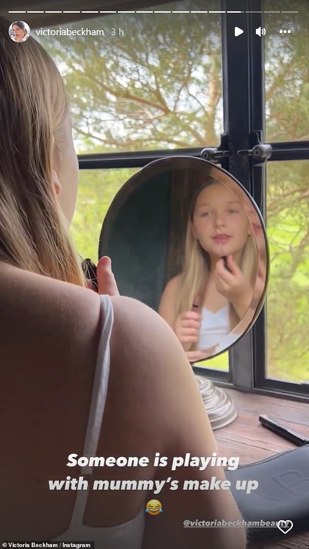 Family fun: Victoria asked Harper for a demonstration, and the daughter then applied the lip-gloss, posing for a smile at the end