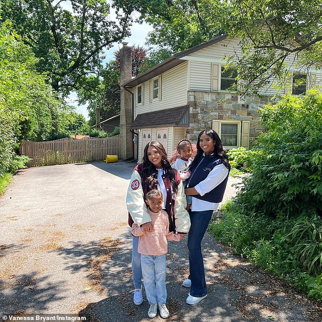 Family first: The slideshow included an image of her with daughters daughters Natalia, 19, Bianka, five, and Capri, two, posing beside a home