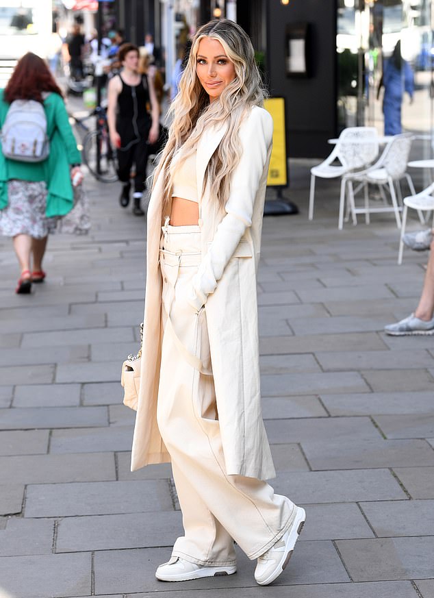 Incredible: The former Love Island star seemed in high spirits as she beamed wearing a scoop neck crop top and matching trousers allowing her to flash her toned midriff