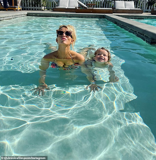 They live to swim: Here Jessica and her mini-me Birdie are seen in the pool in May