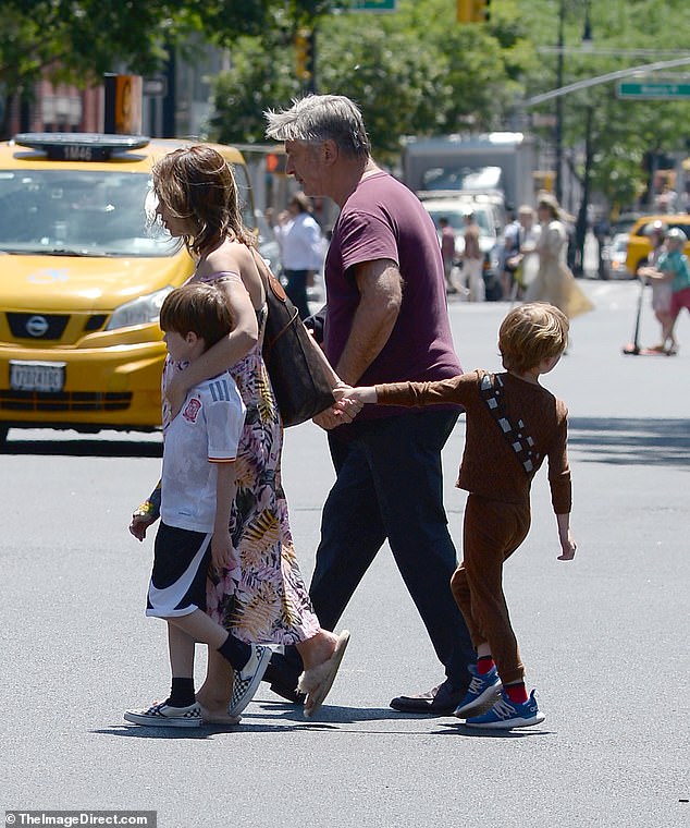 Hands-on parents! Hilaria doted on her children as they carefully crossed the street