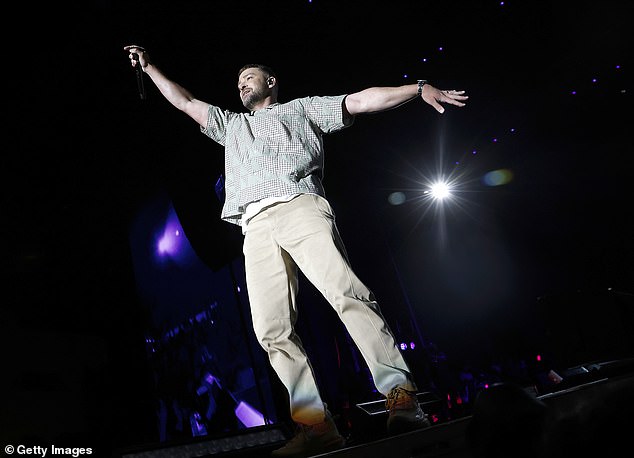 Low key: Justin was dressed for his performance in an unusually casual look featuring a short-sleeve button-up shirt with green triangles and checker patterns, along with khaki pants and chunky tan trainers with red and yellow accents; seen Saturday in Washington, DC