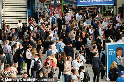 Passengers at London Waterloo station wait for their trains to arrive on Monday ahead of RMT union walkouts this week