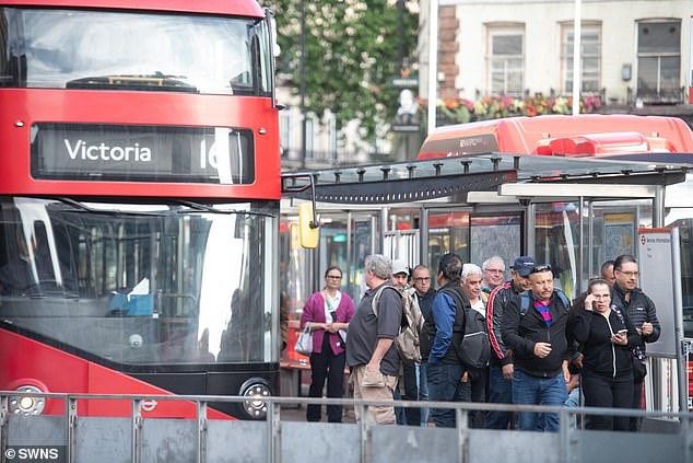 Commuters queueing for buses outside Victoria Station in London amid today's strikes