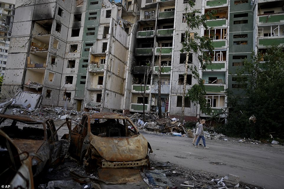 A couple walk past a building destroyed by attacks in Chernihiv, Ukraine, yesterday amid fears of an escalation of the conflict