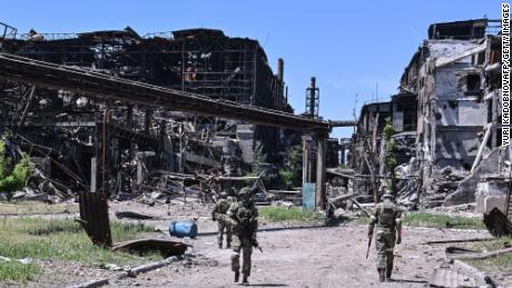 Russian servicemen patrol near the Azovstal steel plant in Mariupol, Ukraine, on June 13, 2022.