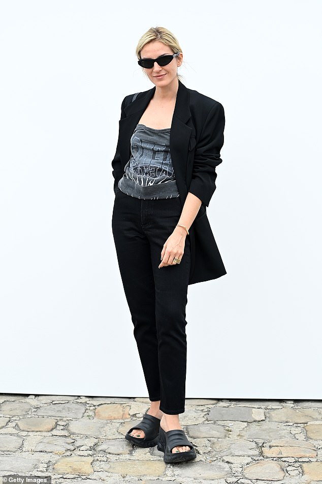 Amazing: Gaia Repossi also stunned in black, wearing dark trousers with a black jacket and graphic shirt