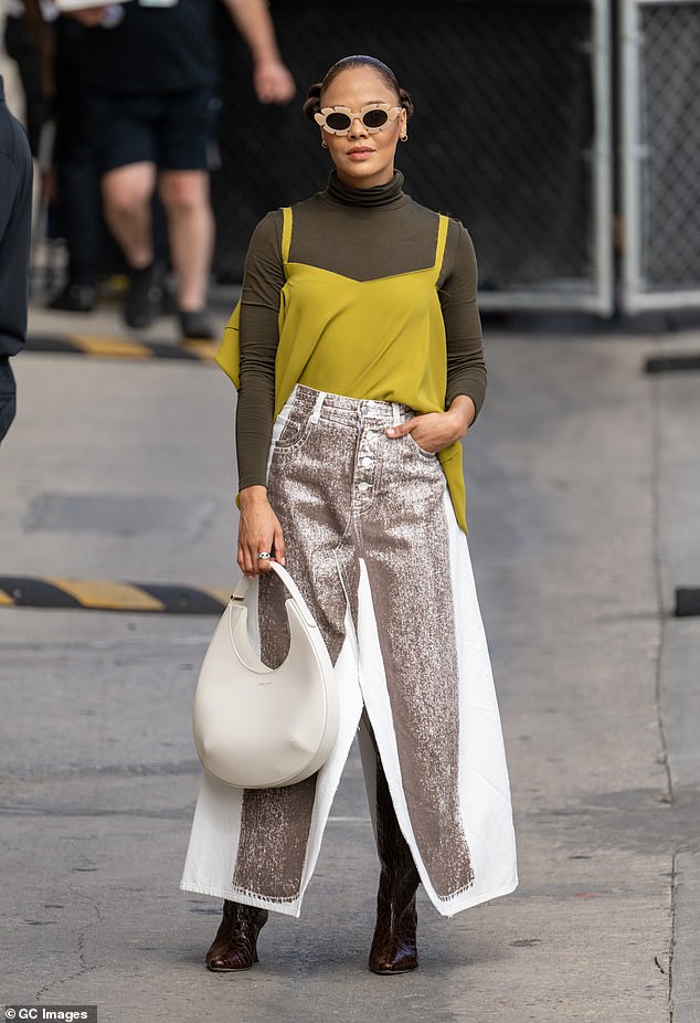 Layers: She teamed the fun look with an olive green turtleneck topped with a chartreuse vest, and finished the attention-commanding ensemble off with snake-print boots