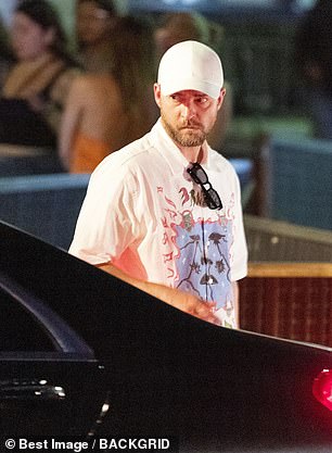 Singer: Justin wore a white top, jeans and a baseball cap as he strolled alongside his wife