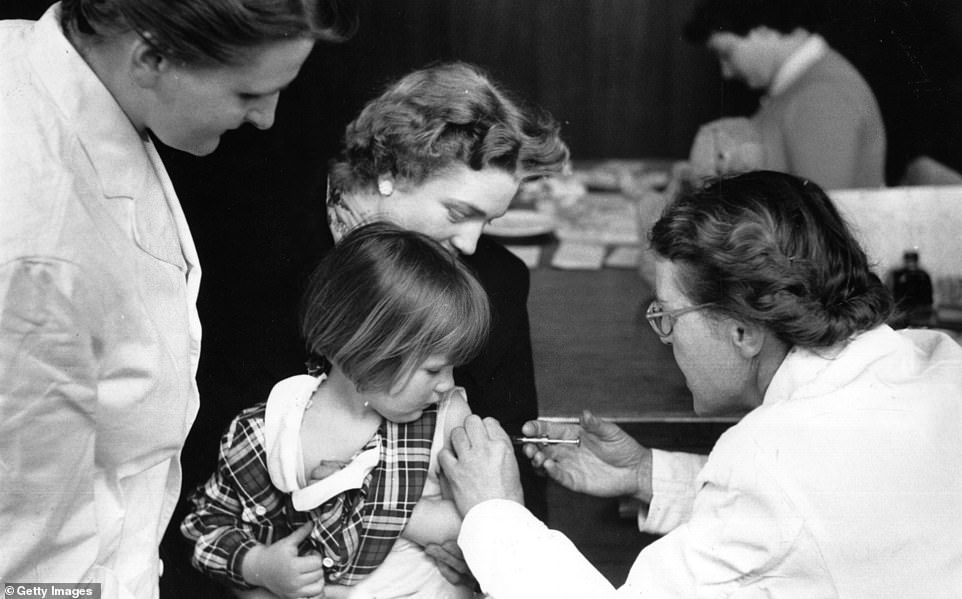 Great Britain was pronounced clear of polio in 2003 with the last case coming in 1984. A young girl is pictured getting her polio jab in May 1956