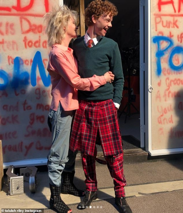 Looking good: Thomas, who rose to fame as a child star in Love Actually, was spotted sporting a red kilt and matching trousers with a crisp white shirt and orange tie