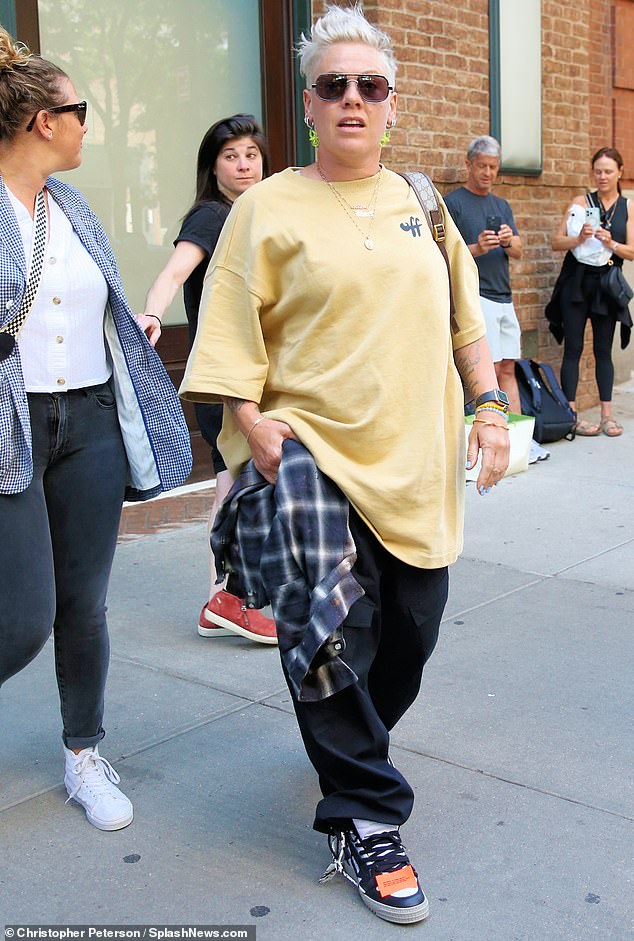 Chic and cool: The singer looked very stylish in an oversized shirt and pants as she stepped out into NYC on Friday