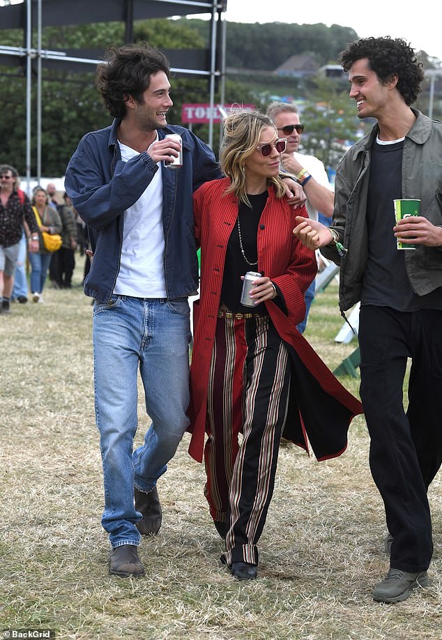 Keeping it casual: Burberry model Oli opted for casual attire, wearing a white T-shirt and a pair of denim jeans