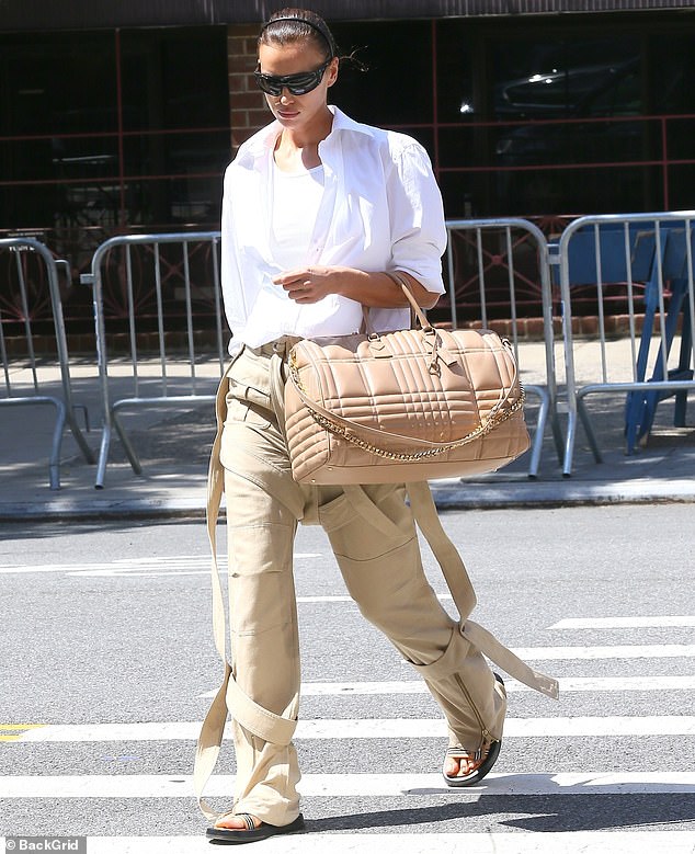 Coffee: The brunette beauty pulled her hair back into a sleek bun and wore dark sunglasses as she  enjoyed a cup of coffee while making her way through The Big Apple