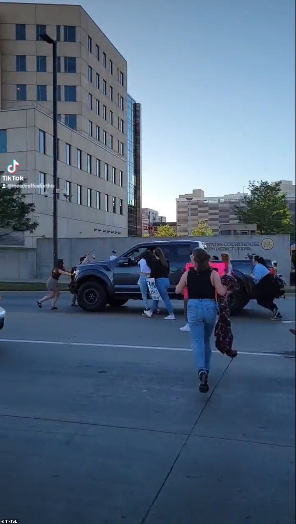 Two people appeared to be in front of the black pickup as it continued driving through the crowd, despite screams