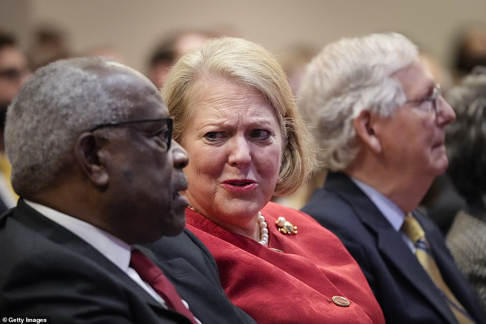 Justice Clarence Thomas is pictured with his wife, Ginni - a controversial conservative activist, who was in touch with a key Trump adviser during the January 6 insurrection