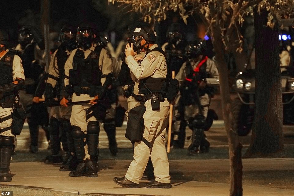 PHOENIX: Riot police surround the state capitol after protesters reached the front of the Senate building and tried to break the glass