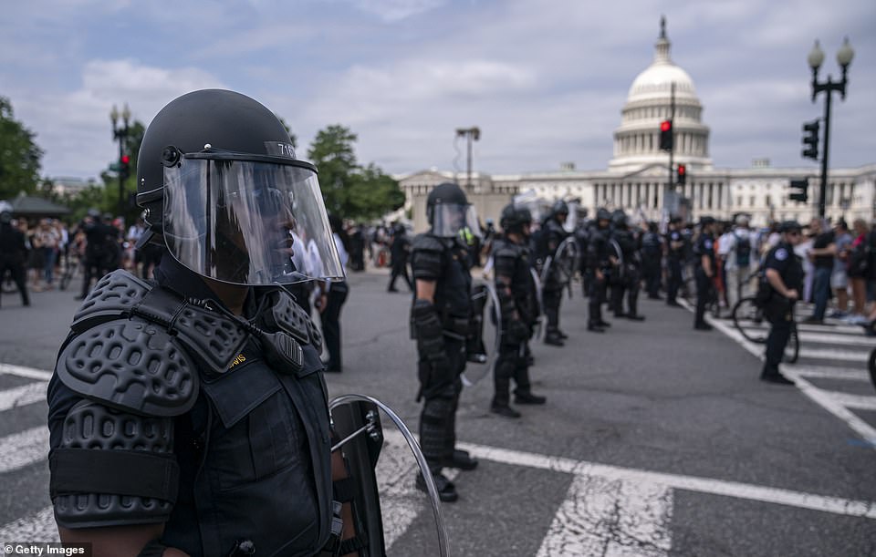 WASHINGTON DC: Capitol Police dressed in riot gear stand outside the Capitol on Friday evening as protests erupted