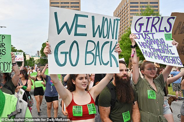 ATLANTA: A woman and a man in Georgia wear stickers proclaiming: 'Forced motherhood is female enslavement'