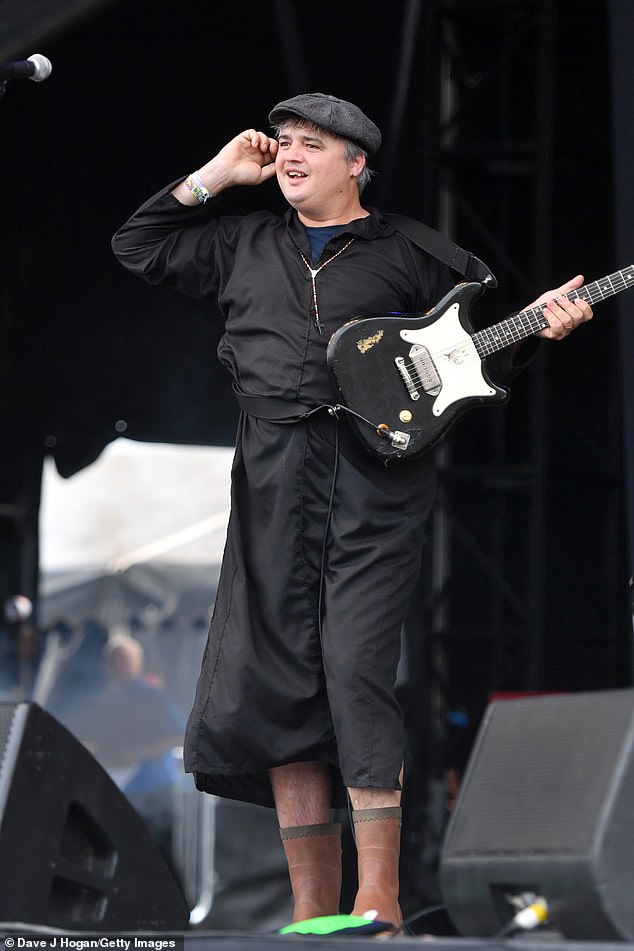 Festival: In true Glastonbury style he added brown wellies and also sported a cross chain around his neck