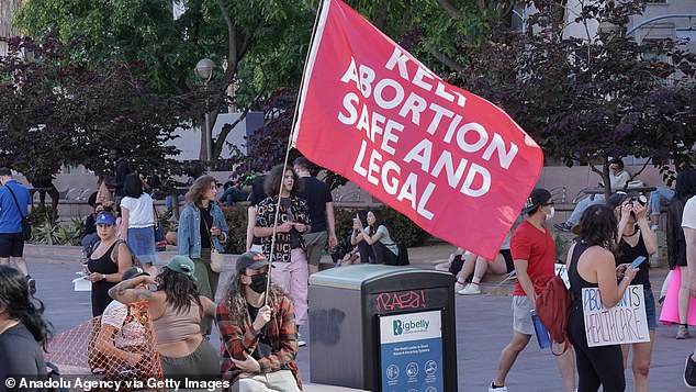 Protesters in Los Angeles (above) took to the streets with flags and signs to protest the US Supreme Court's decision to overturn the Roe v. Wade ruling