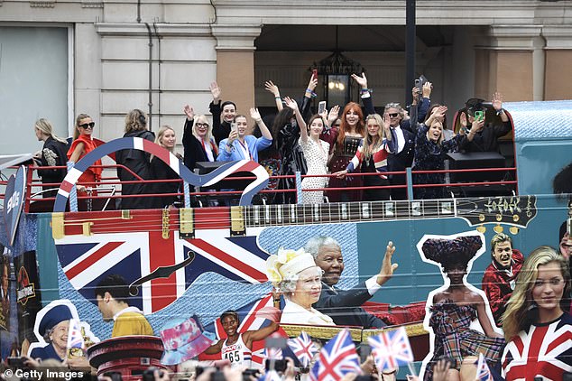 Patriotic: Donning a Union Jack jacket for the Jubilee celebrations, the model stood at the top of the open-top bus, which also featured her picture down the side, as it made it's way through the capital