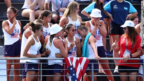 Members of the United States team react as Anita Alvarez is attended to by medical staff.