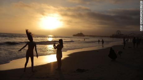 Women dance on the beach in Santa Monica, California earlier this week.