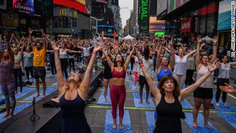 Yogis take part in a summer solitice event in Times Square on Tuesday.