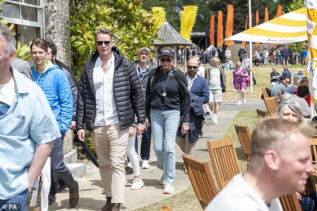 Relaxed: She teamed this with pale blue jeans and white trainers, while she shielded her eyes from the sun with stylish tortoiseshell sunglasses