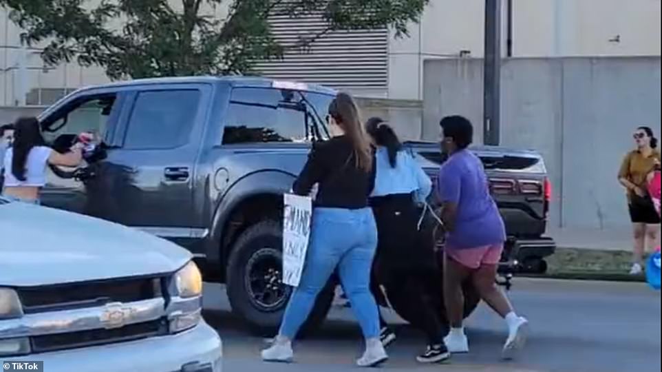 The driver continued accelerating, despite the protesters all around him and in front