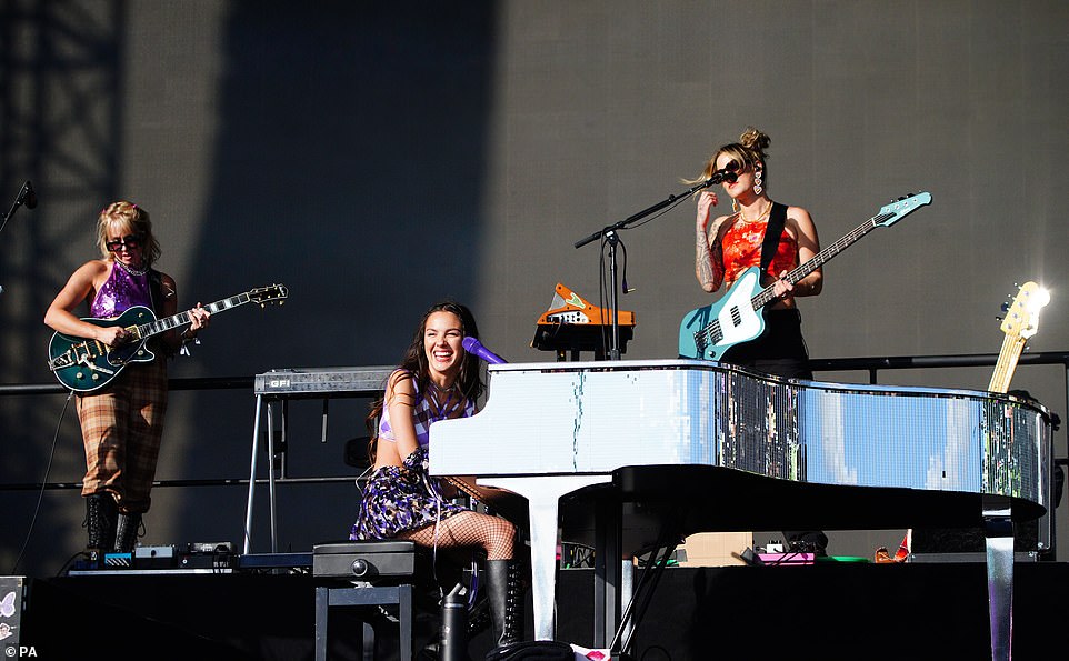 Making music: For some songs she sat and played the piano, while for others she perched on top of the instrument to sing to her fans