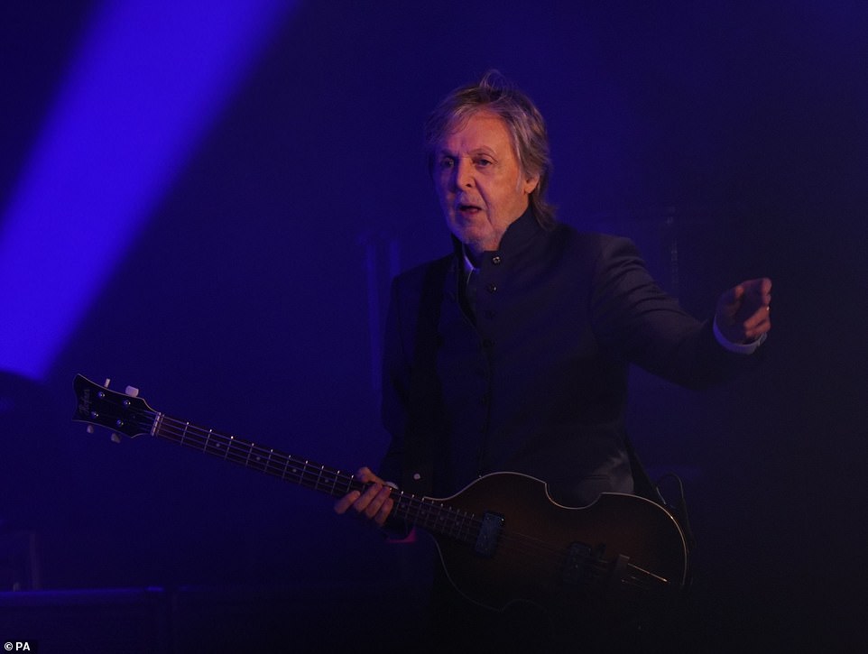 Dapper: The performer donned a smary navy blue Nehru jacket for the opening moments of his headline set, but later removed it, telling the crowd it would be his 'only wardrobe change of the night'