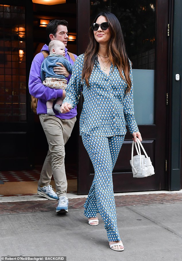 Casual: Mulaney kept it relatively casual in a light purple hoodie and slim-fitting beige pants during his outing. The former Saturday Night Live writer also sported a backpack and a pair of multicolored Nike sneakers as he held his baby son